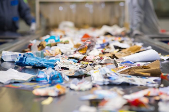 view of waste paper on a conveyor belt